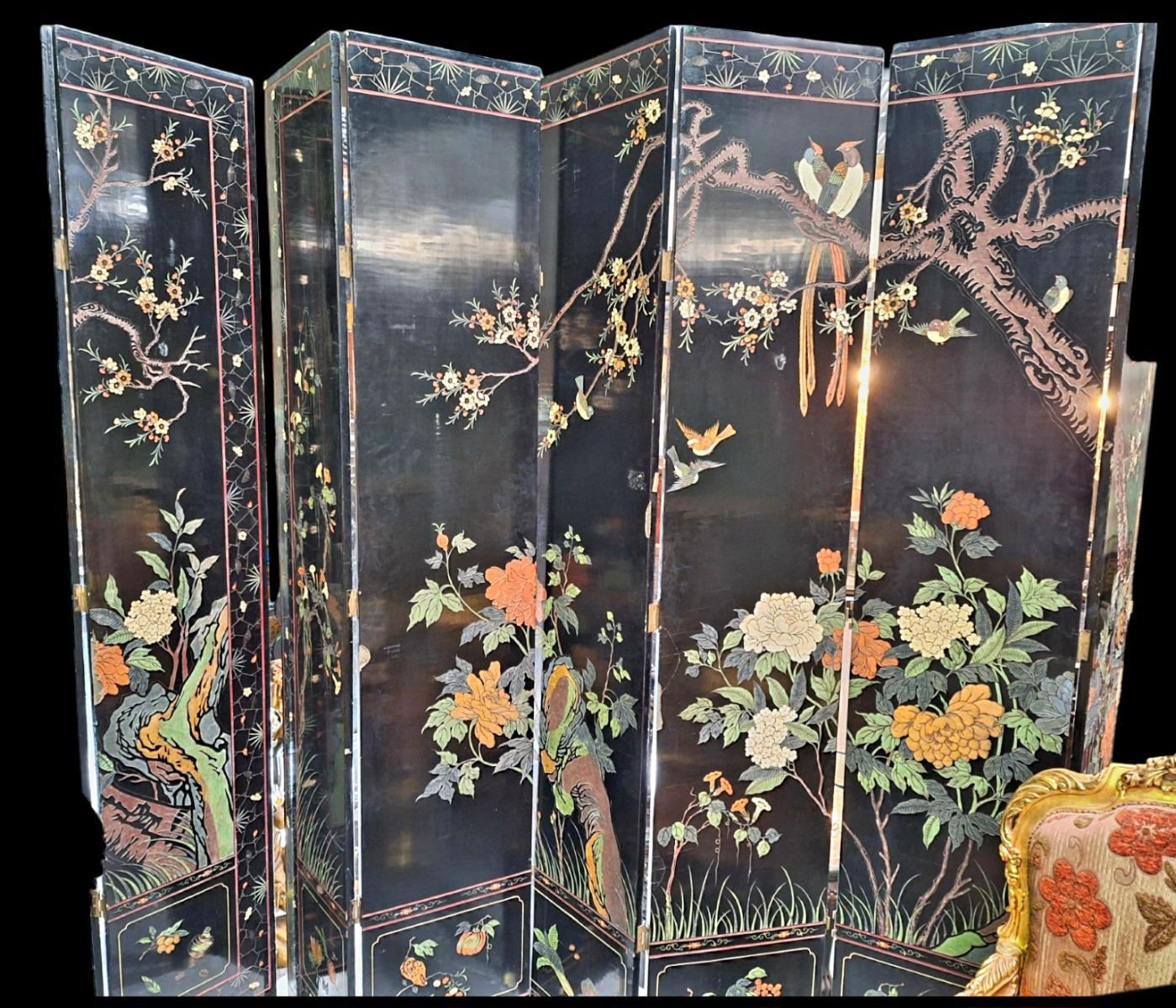 A large decorative screen in Chinese lacquer with both sides different floral scenes guilded and polychrome colours.