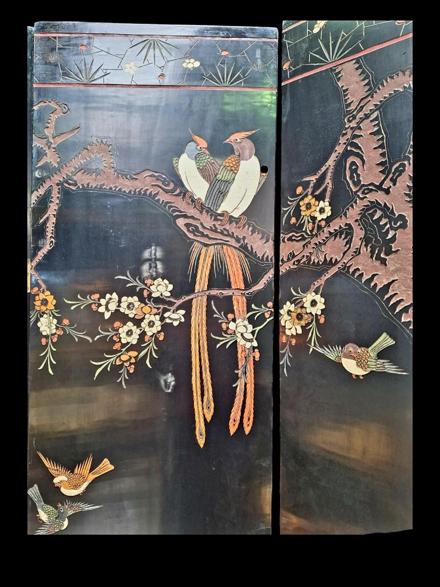 A large decorative screen in Chinese lacquer with both sides different floral scenes guilded and polychrome colours.