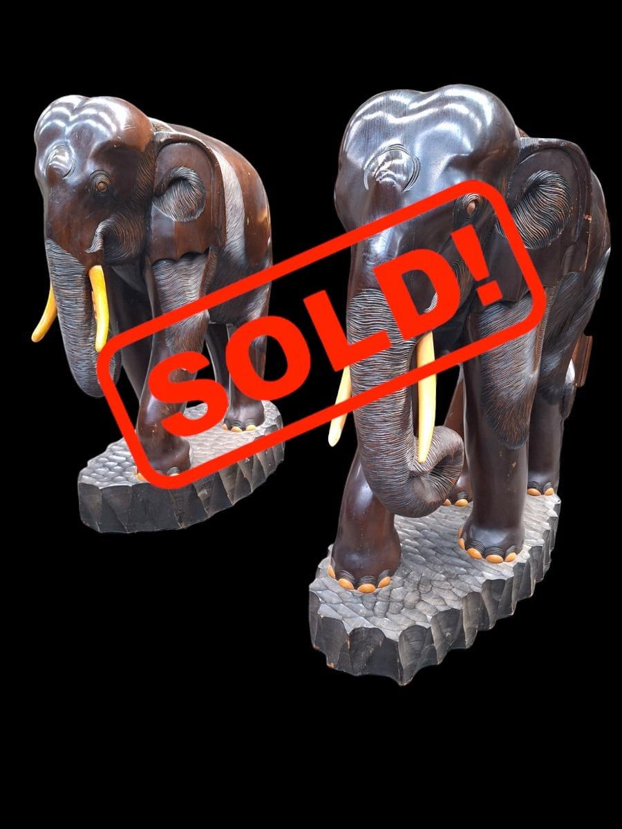 A pair of dark hardwood elephants.