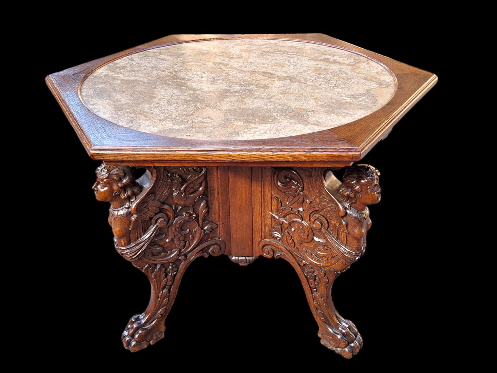 A tripod oak center table.