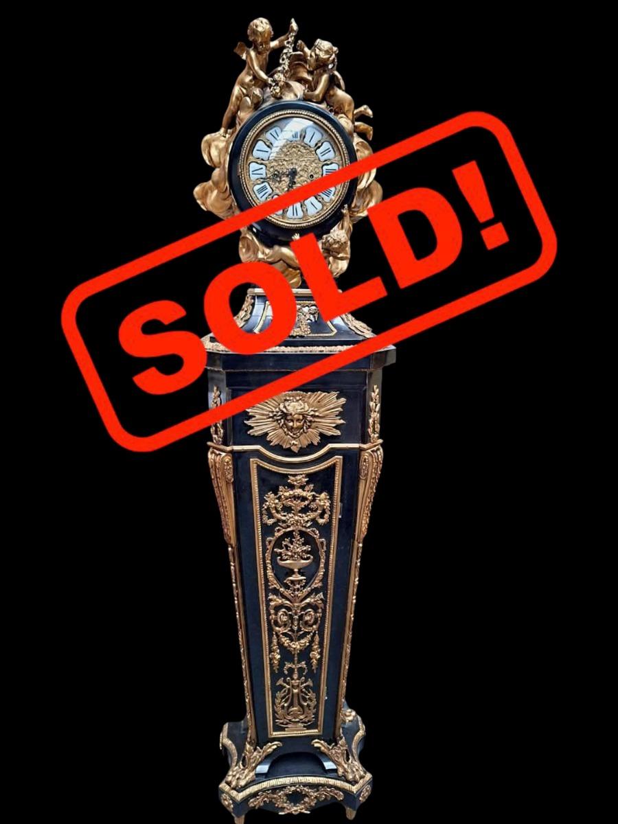 Clock in ebonized wood and ormolu mounts.