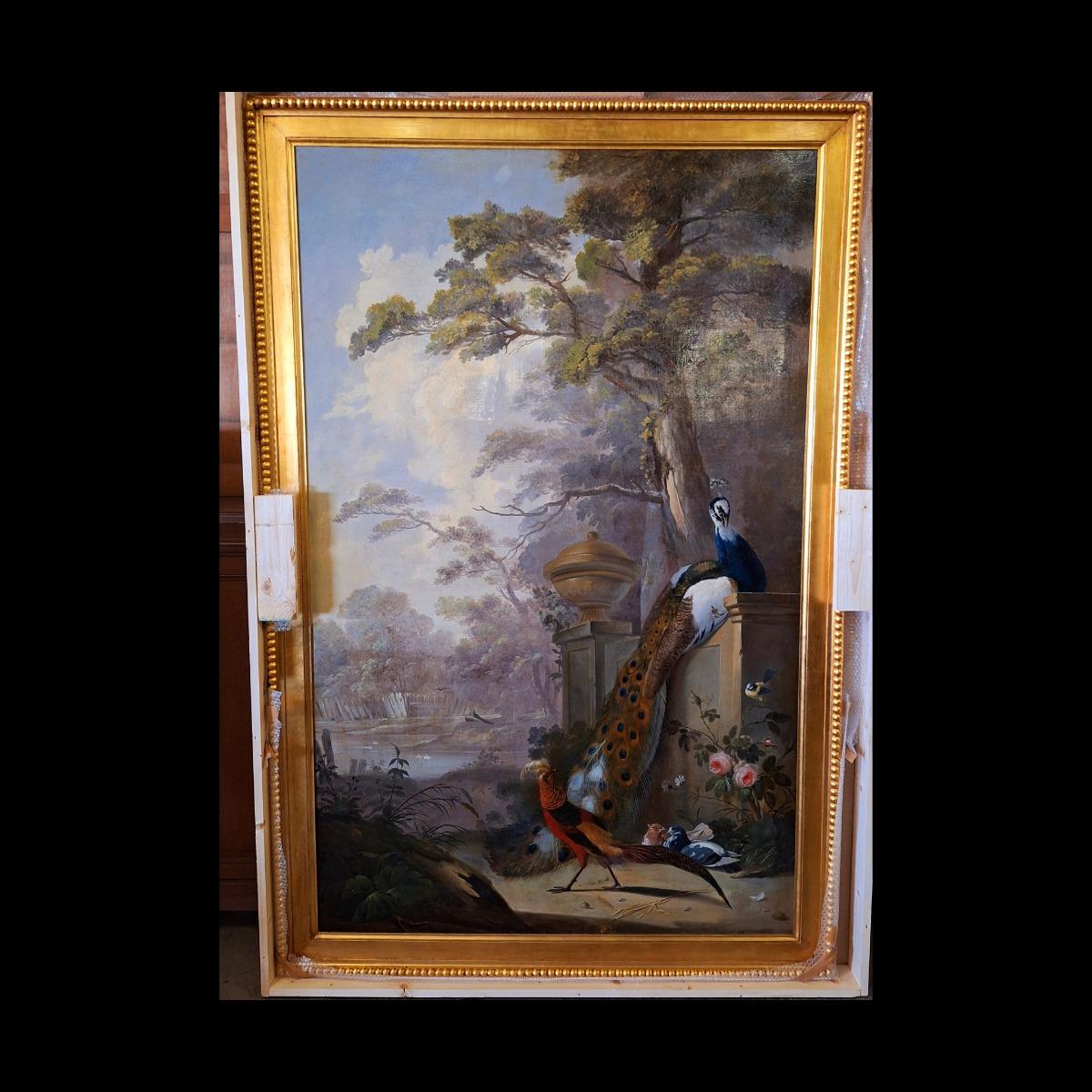 Large and very decorative painting with peacock and birds in a guilded frame from wood with stucco