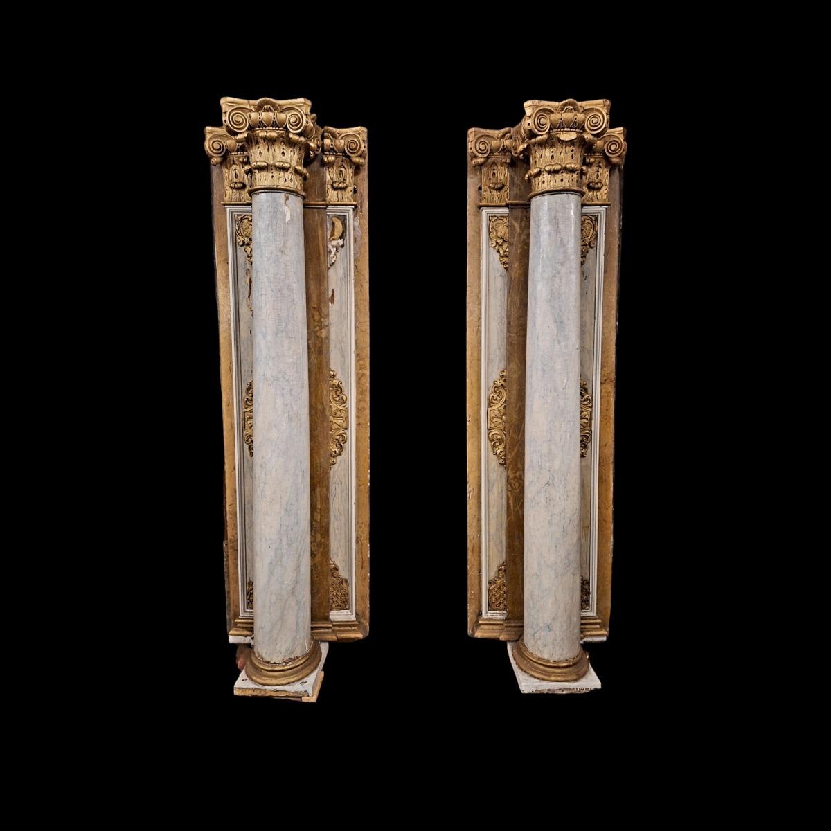 Pair of wooden Corinthian style columns.