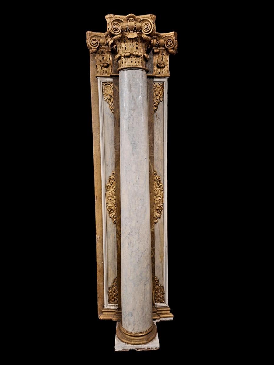 Pair of wooden Corinthian style columns.