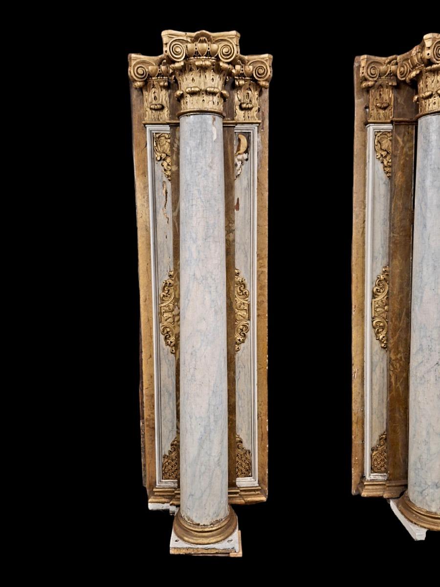 Pair of wooden Corinthian style columns.