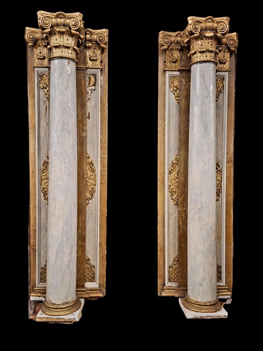 Pair of wooden Corinthian style columns.