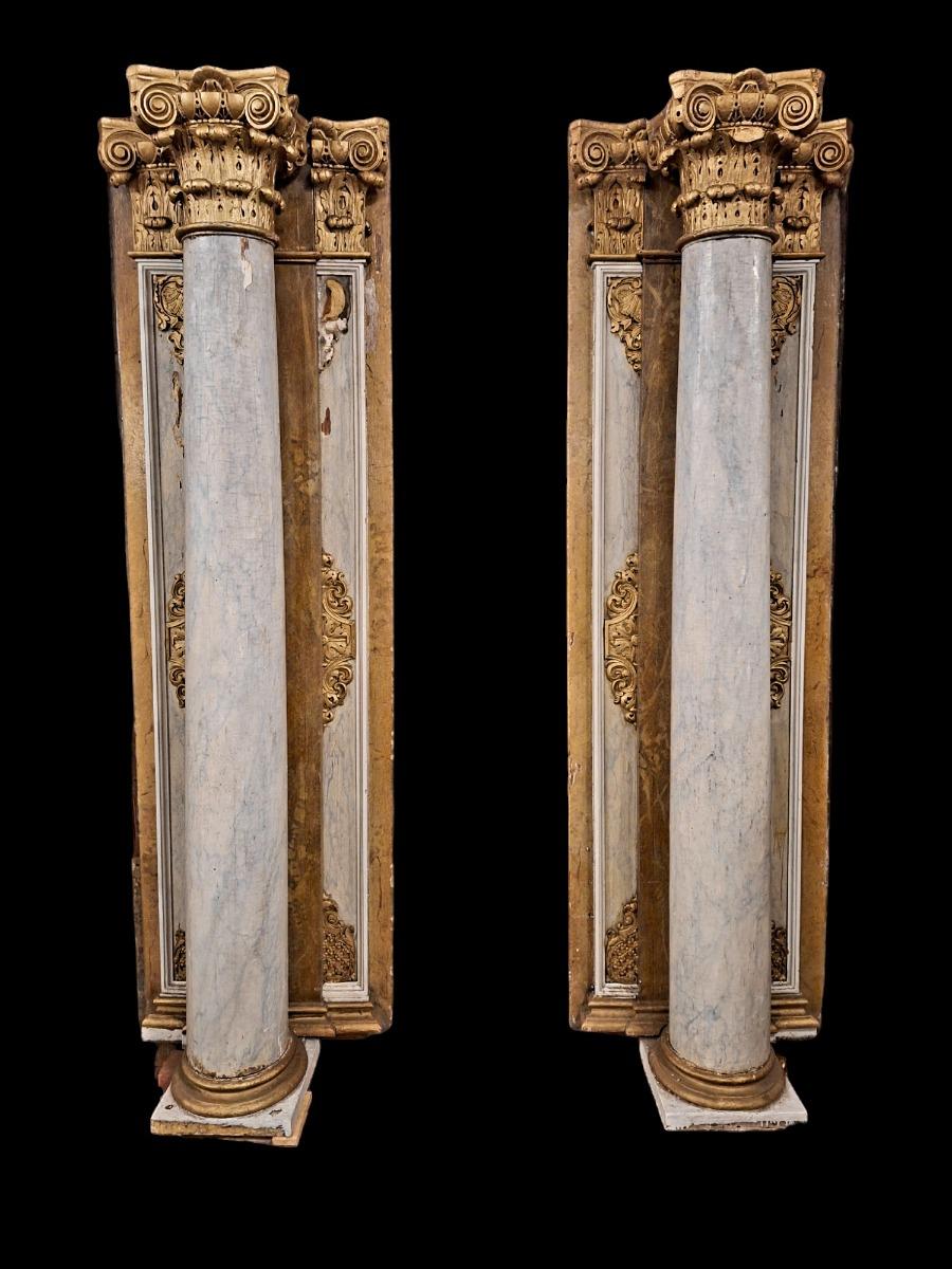 Pair of wooden Corinthian style columns.