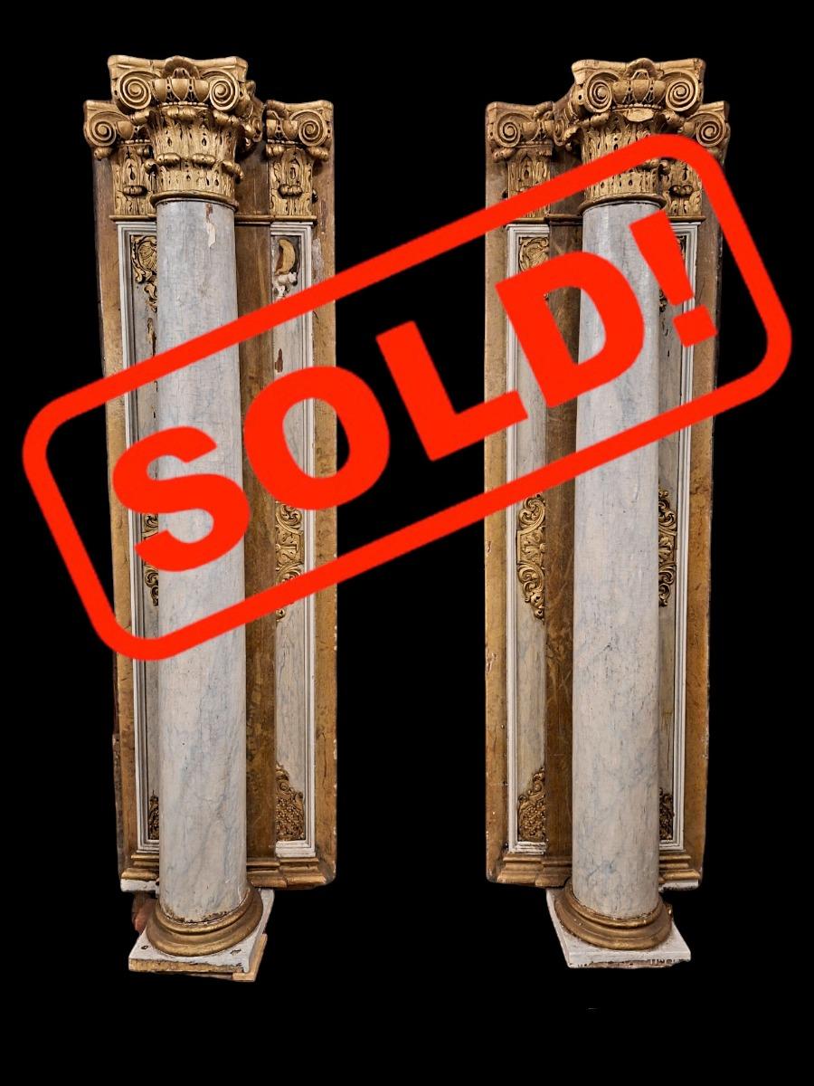 Pair of wooden Corinthian style columns.