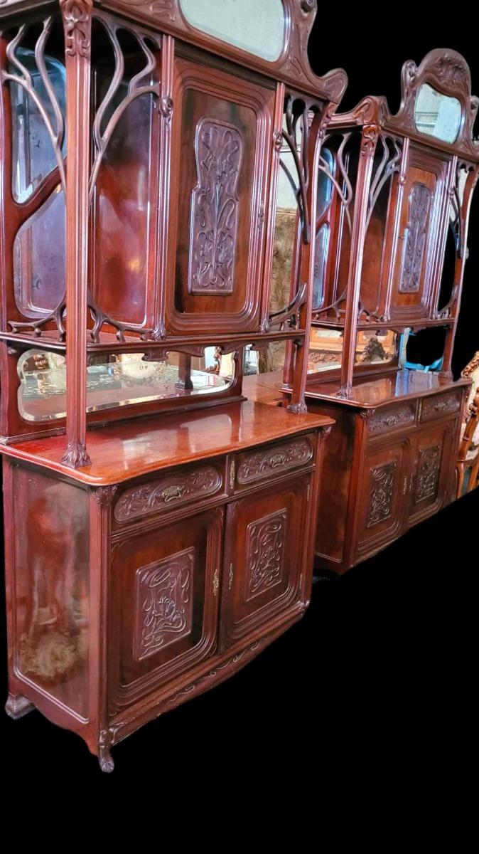 Very nice pair of Mahogany carved cabinets in ArtNouveau style with carved paneled doors and beveld mirrors.