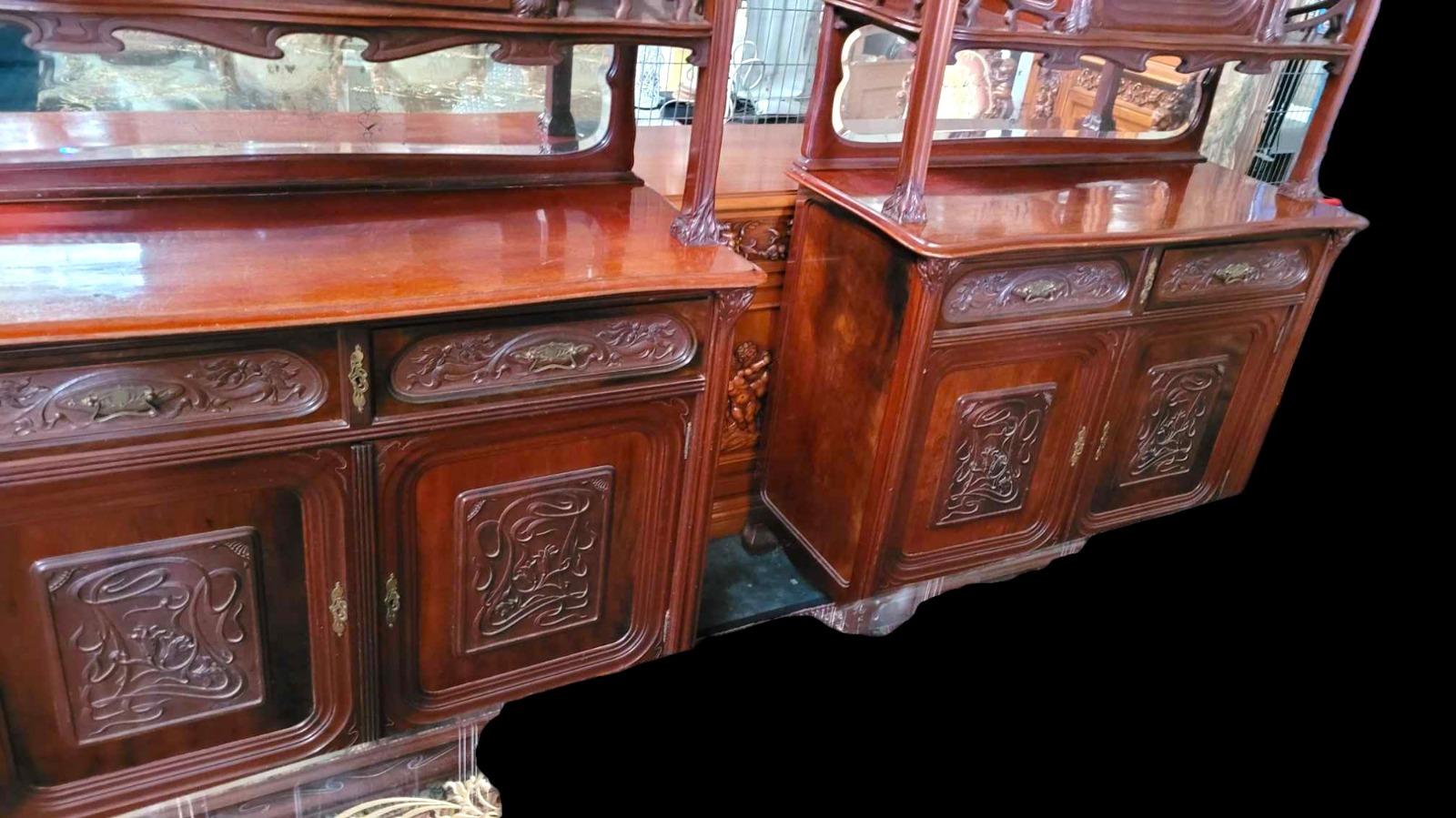 Very nice pair of Mahogany carved cabinets in ArtNouveau style with carved paneled doors and beveld mirrors.
