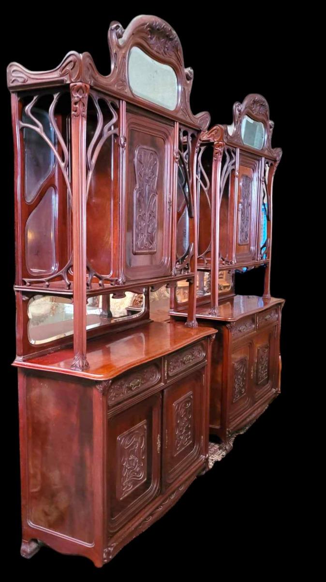 Very nice pair of Mahogany carved cabinets in ArtNouveau style with carved paneled doors and beveld mirrors.